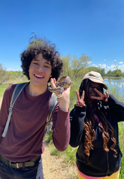 AXL 8th grade student holding a bullsnake he found on the overnight trip